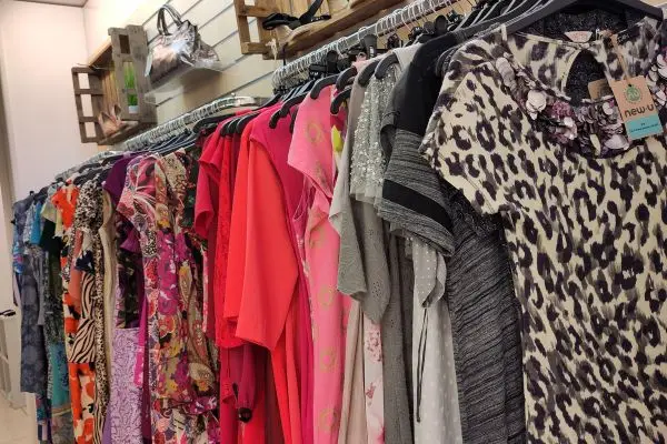 Row of colourful dresses hanging in the shop