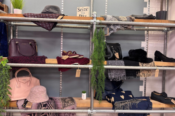 Shelf with range of autumn accessories such as hats, scarves bags and shoes